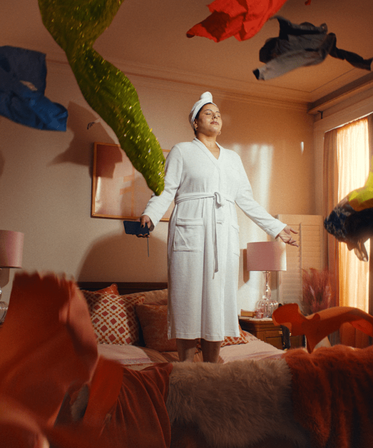 ebay campaign woman standing in living room full of products flying around